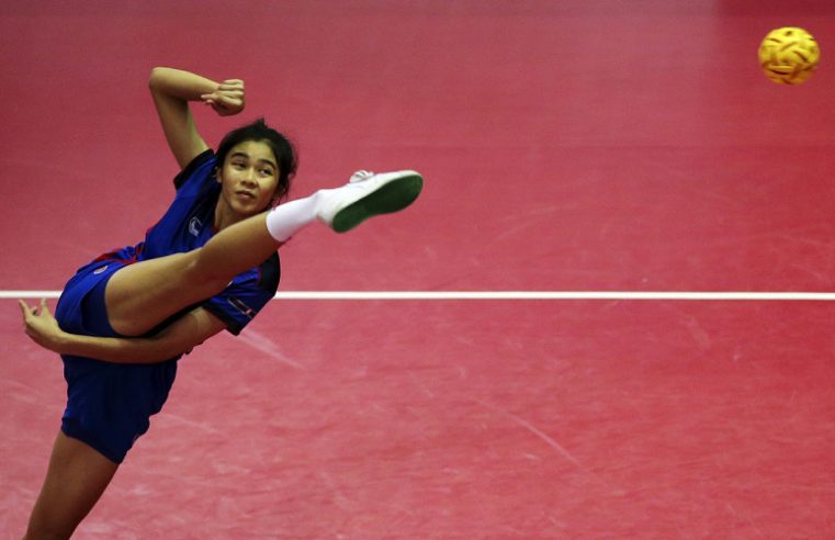 Image Showing Woman sepak-takraw player kick the ball during tournament