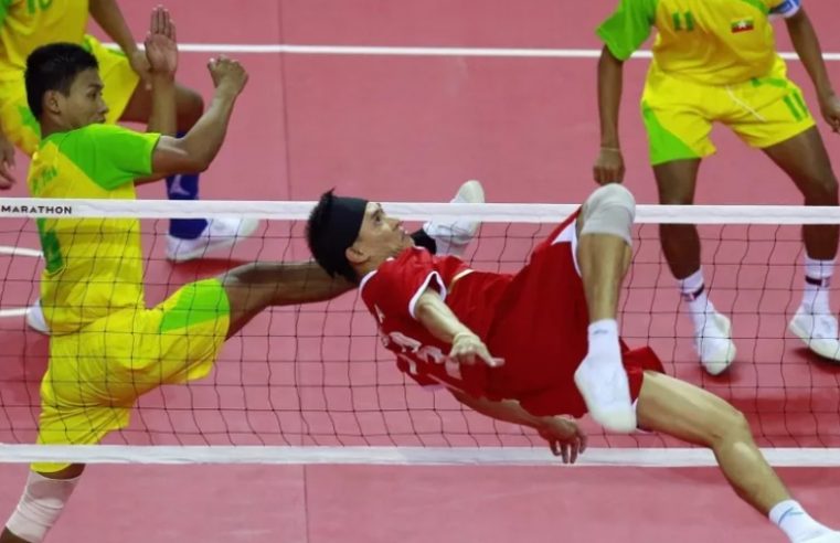 Sepak takraw player action in a sepak-takraw stadium