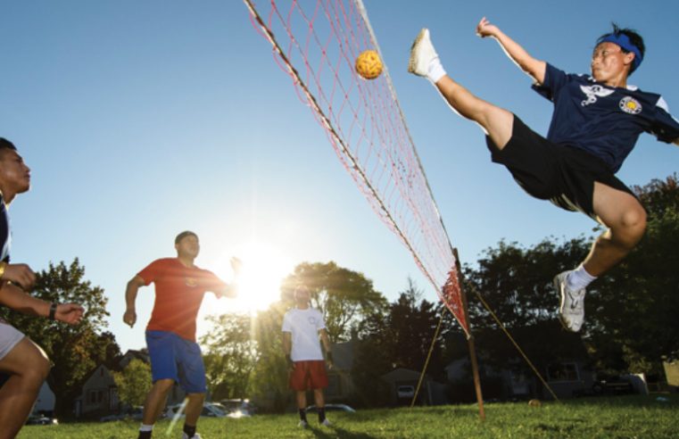 Group of Players playing sepak-takraw in a sunny day