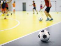 Indoor futsal soccer players playing