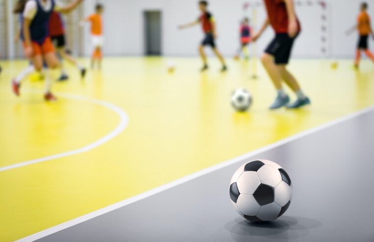 Indoor futsal soccer players playing